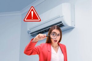condizionatore donna con lente ingrandimento segnale pericolo